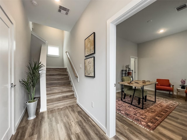 stairway featuring wood-type flooring