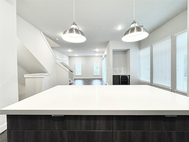 kitchen featuring hanging light fixtures, hardwood / wood-style floors, and a spacious island