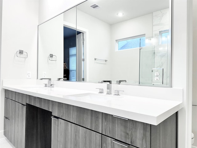 bathroom featuring vanity and an enclosed shower