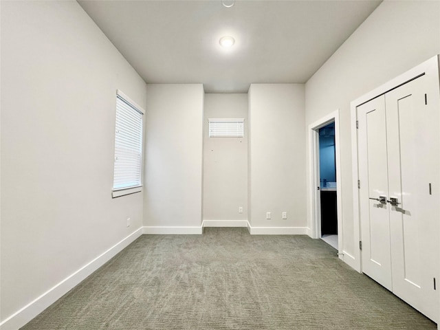 unfurnished bedroom with light colored carpet