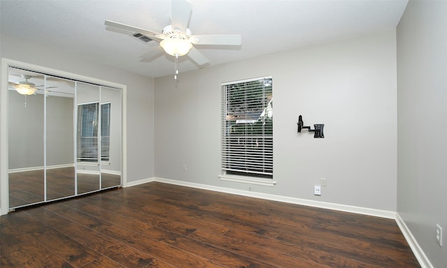 spare room featuring dark hardwood / wood-style floors and ceiling fan