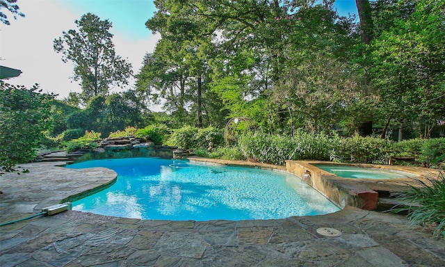 view of swimming pool featuring an in ground hot tub