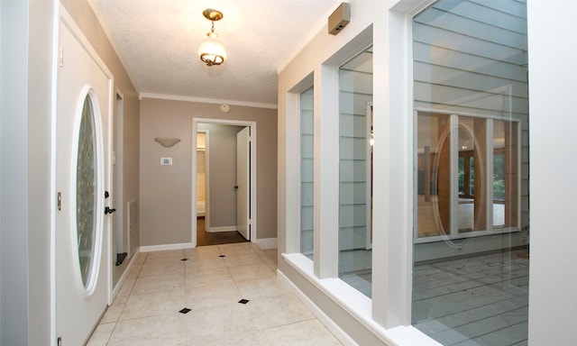 interior space with light tile patterned floors, a textured ceiling, and crown molding