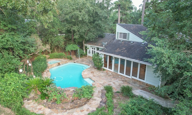 view of pool featuring an in ground hot tub and a patio