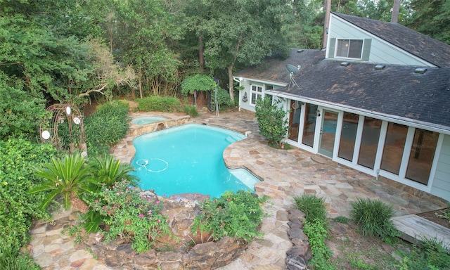 view of pool with a patio area and an in ground hot tub