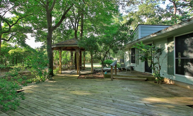 wooden terrace featuring a gazebo