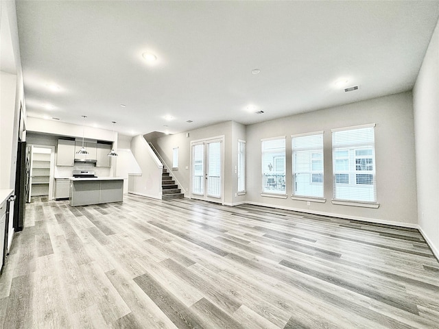 unfurnished living room featuring light hardwood / wood-style flooring