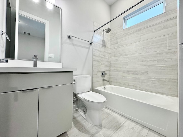 full bathroom featuring toilet, vanity, and tiled shower / bath