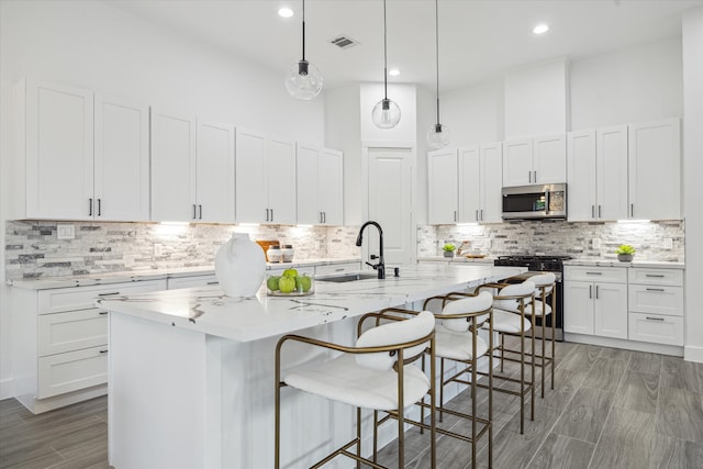 kitchen with white cabinetry, sink, and appliances with stainless steel finishes