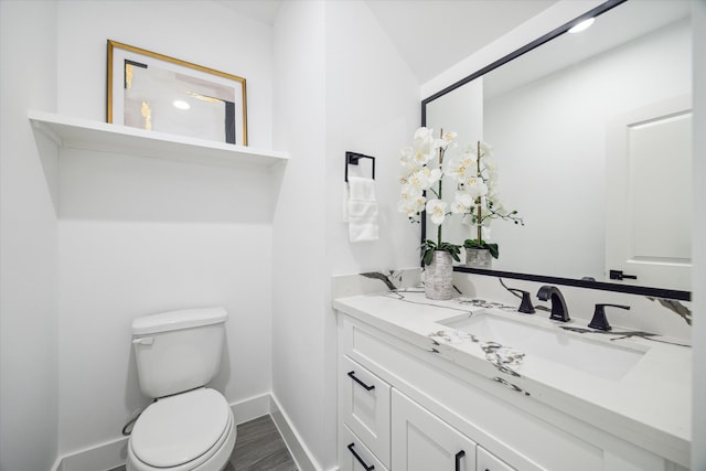 bathroom featuring hardwood / wood-style floors, vanity, and toilet