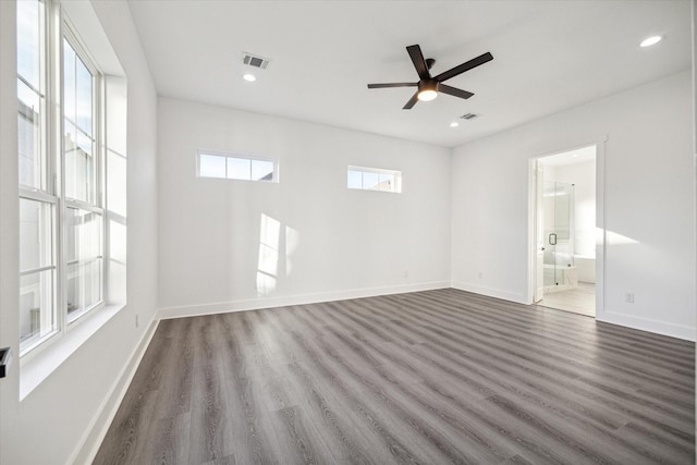 spare room with dark wood-type flooring and ceiling fan