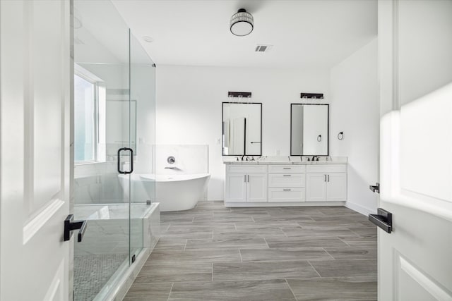 bathroom featuring vanity and plus walk in shower