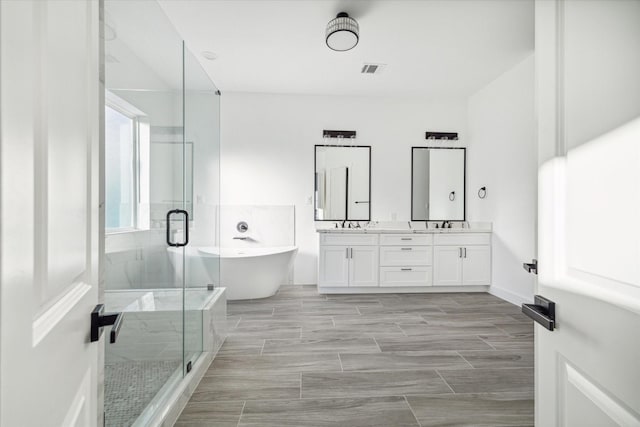 bathroom with vanity and separate shower and tub