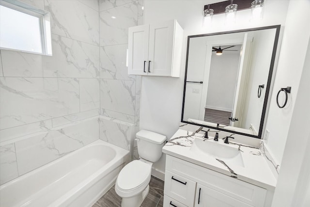 full bathroom with tiled shower / bath combo, vanity, and toilet