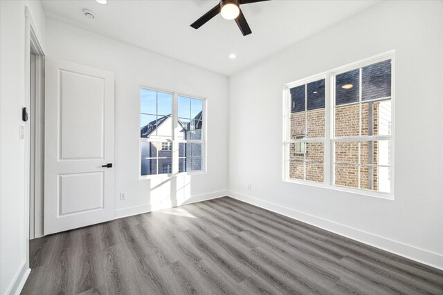 spare room featuring ceiling fan and dark wood-type flooring