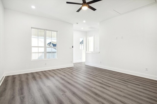 unfurnished room with ceiling fan and dark hardwood / wood-style flooring