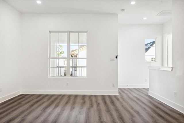 spare room featuring hardwood / wood-style flooring and a wealth of natural light