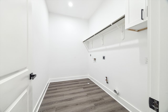 laundry area featuring cabinets, electric dryer hookup, hookup for a gas dryer, dark hardwood / wood-style floors, and hookup for a washing machine