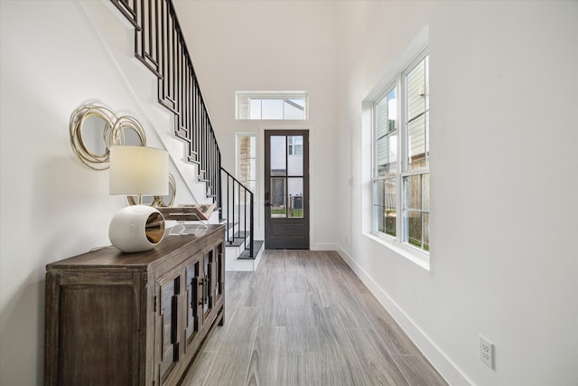 entrance foyer with plenty of natural light and light hardwood / wood-style floors