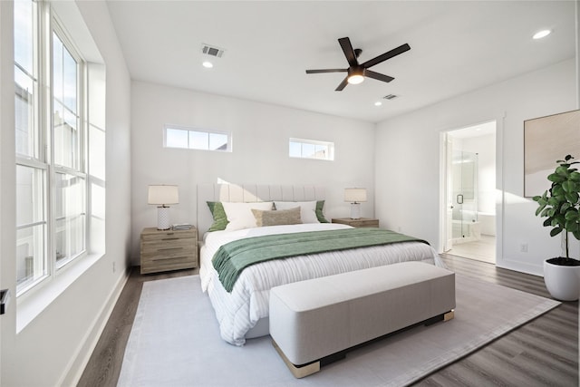 bedroom with wood-type flooring, connected bathroom, and ceiling fan