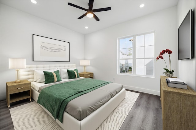 bedroom with dark hardwood / wood-style floors and ceiling fan