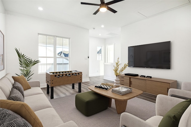 living room featuring light hardwood / wood-style flooring and ceiling fan