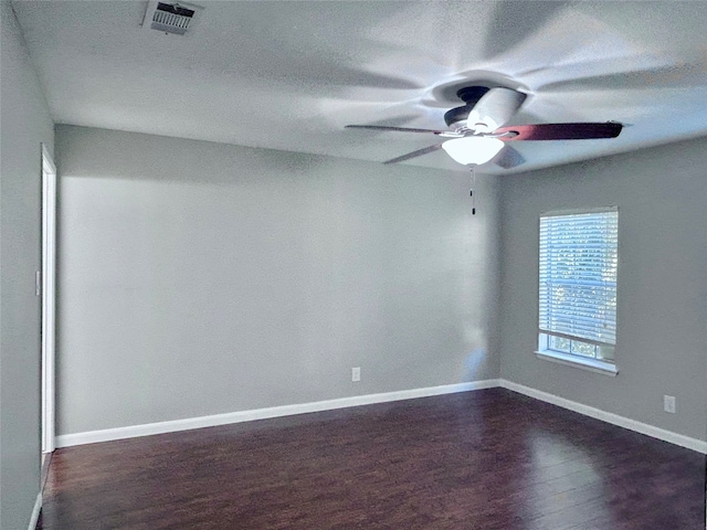 empty room featuring dark hardwood / wood-style floors and ceiling fan