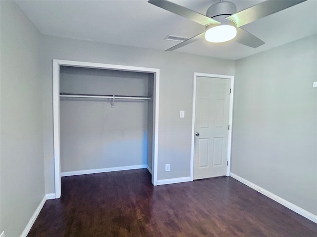 unfurnished bedroom featuring dark hardwood / wood-style flooring, a closet, and ceiling fan