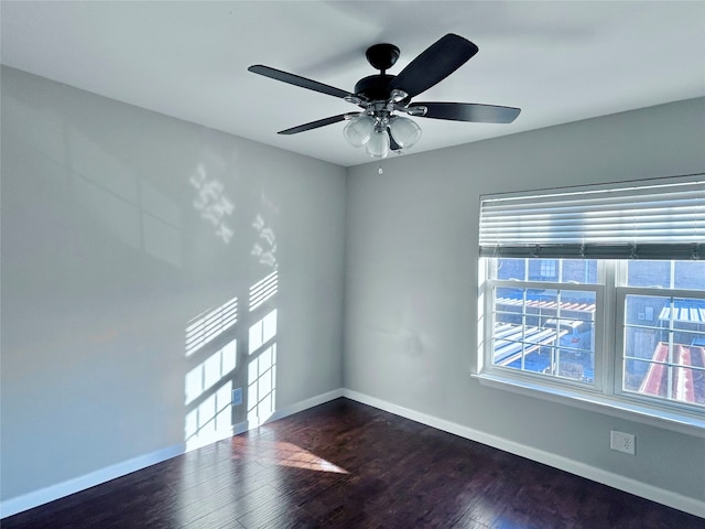 unfurnished room featuring ceiling fan and dark wood-type flooring