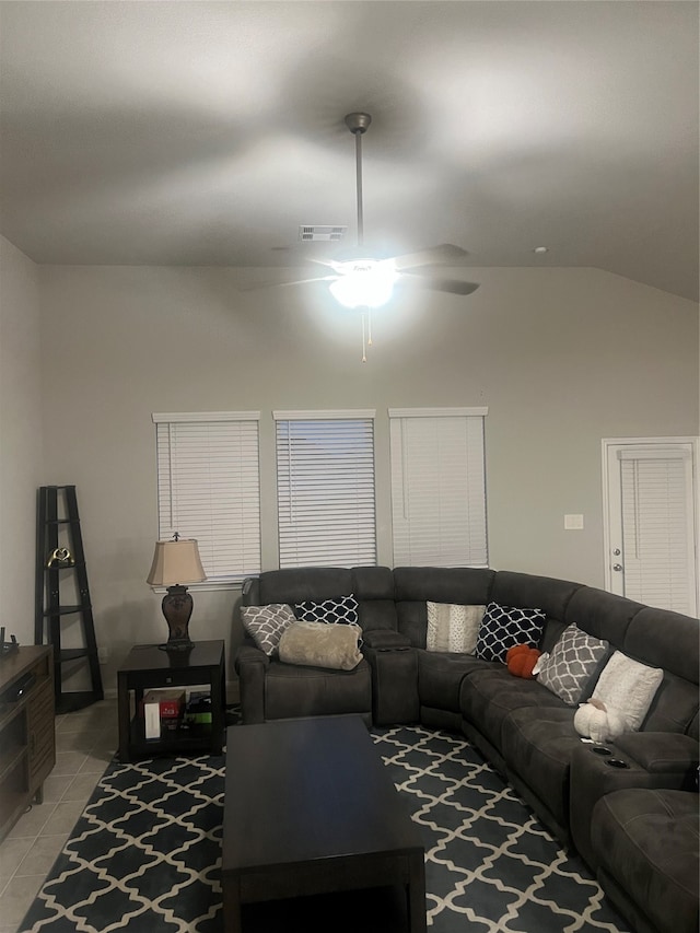 living room with lofted ceiling, ceiling fan, and light tile patterned floors