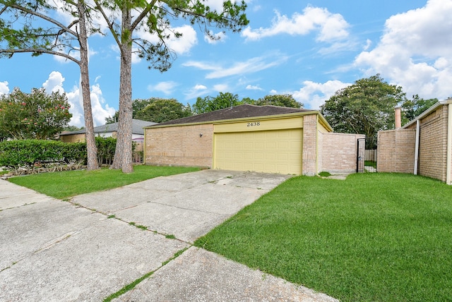 exterior space featuring a garage and a lawn