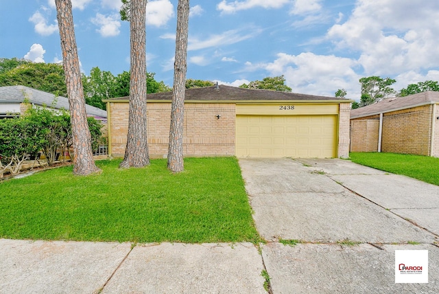 view of front of house with a garage and a front yard