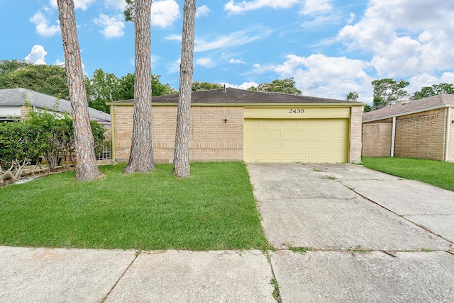 exterior space featuring a garage and a front lawn