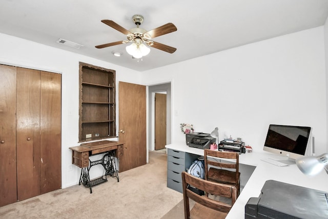 carpeted office space featuring ceiling fan