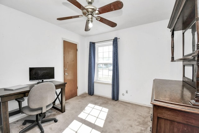 carpeted home office with ceiling fan