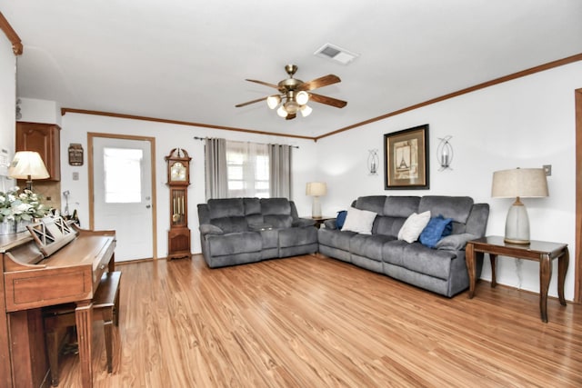 living room featuring ceiling fan, light hardwood / wood-style floors, and ornamental molding