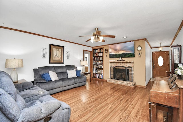 living room featuring a fireplace, ceiling fan, light hardwood / wood-style flooring, and ornamental molding