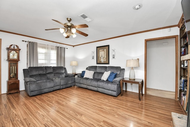 living room with light hardwood / wood-style floors, ceiling fan, and crown molding