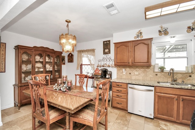 dining area with sink and an inviting chandelier