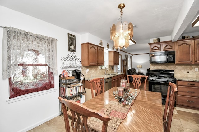 tiled dining space featuring an inviting chandelier and sink