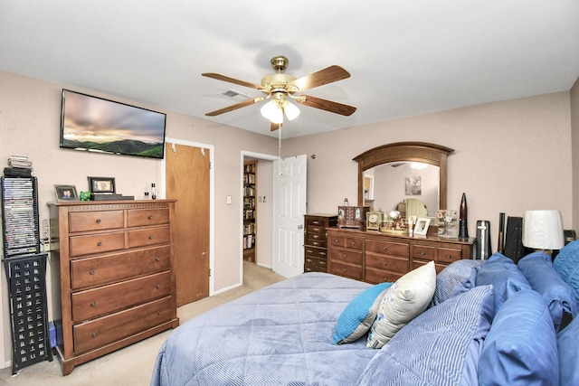 bedroom featuring ceiling fan and light carpet