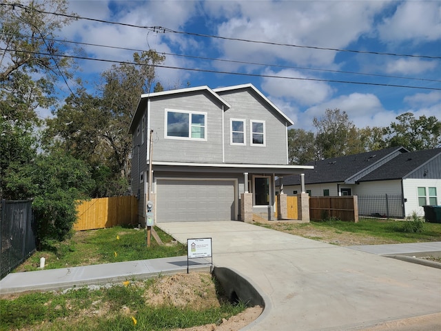 view of front of property featuring a front yard and a garage