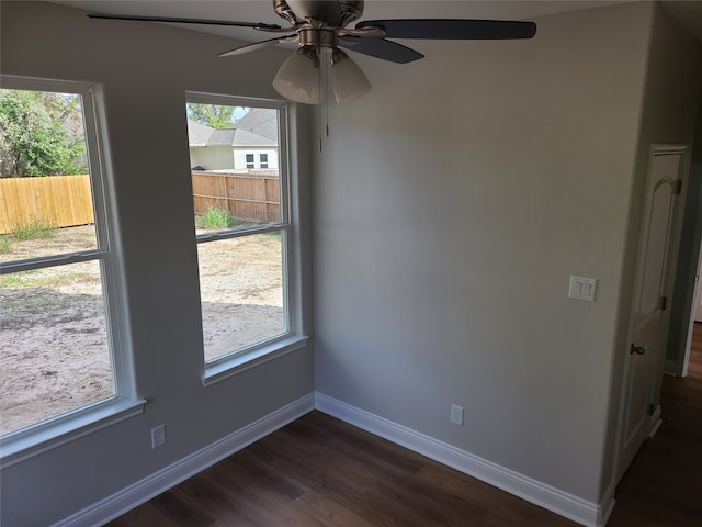 unfurnished dining area featuring ceiling fan and dark wood-type flooring