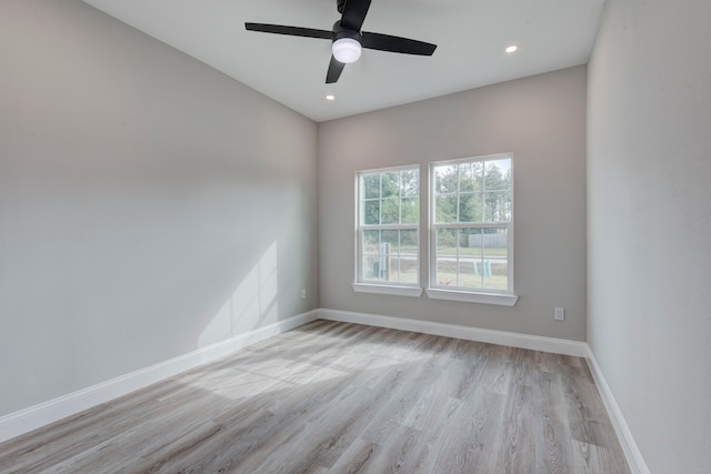 empty room with ceiling fan and light hardwood / wood-style floors