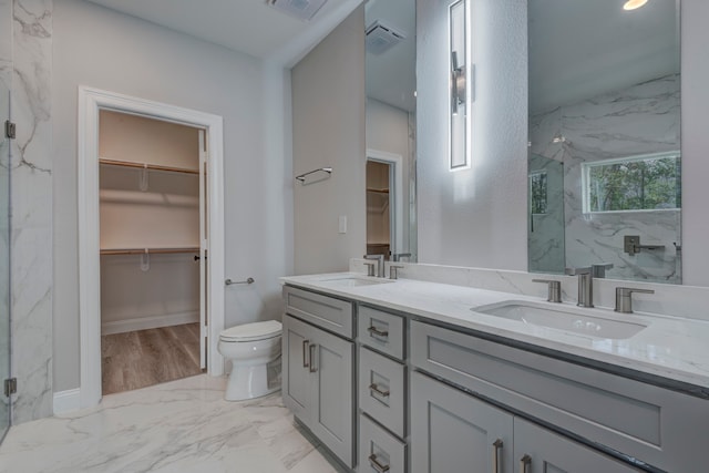 bathroom with hardwood / wood-style floors, vanity, toilet, and an enclosed shower