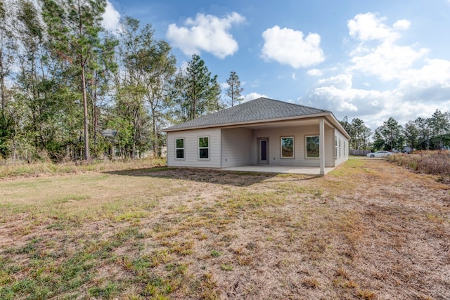 back of house featuring a patio area and a yard