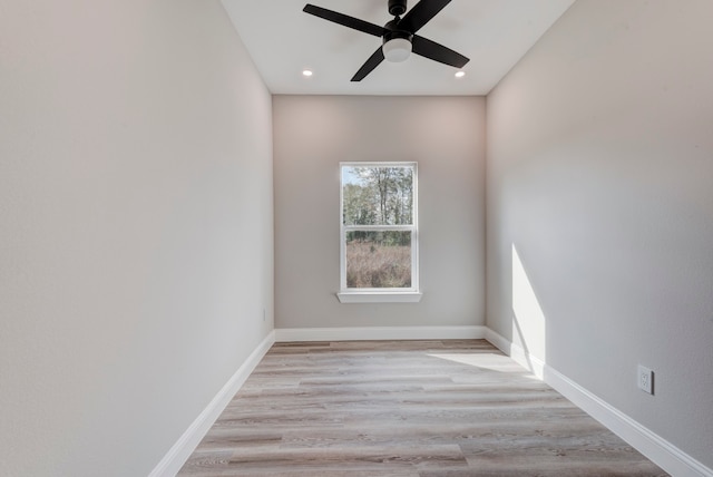 empty room featuring light wood-type flooring and ceiling fan