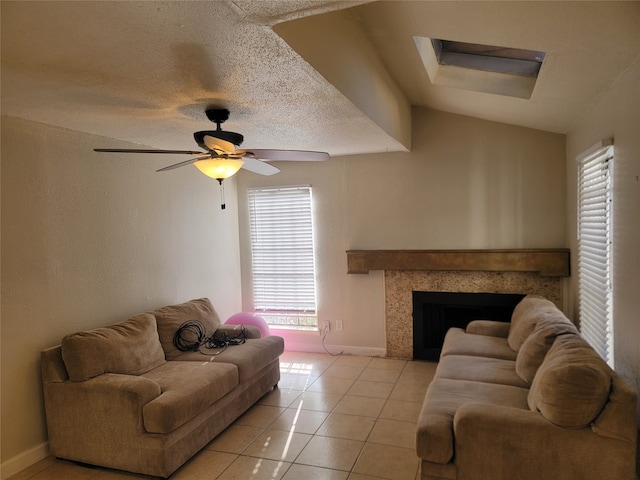 tiled living room with ceiling fan, lofted ceiling, and a textured ceiling