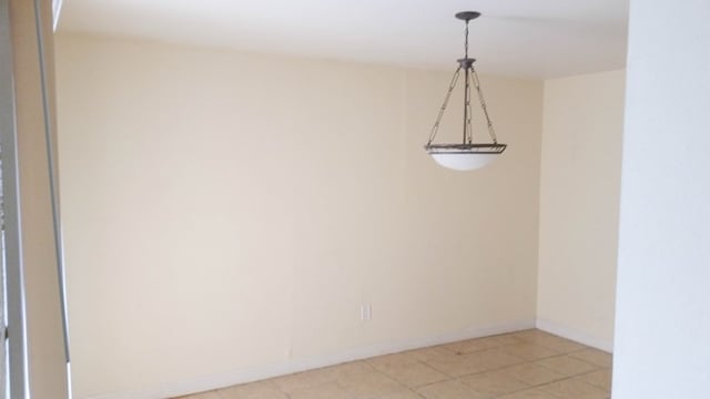 unfurnished room with light tile patterned flooring