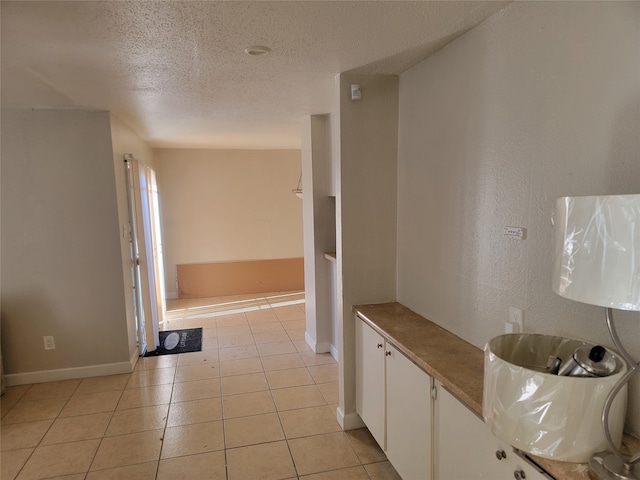 interior space with tile patterned floors and a textured ceiling